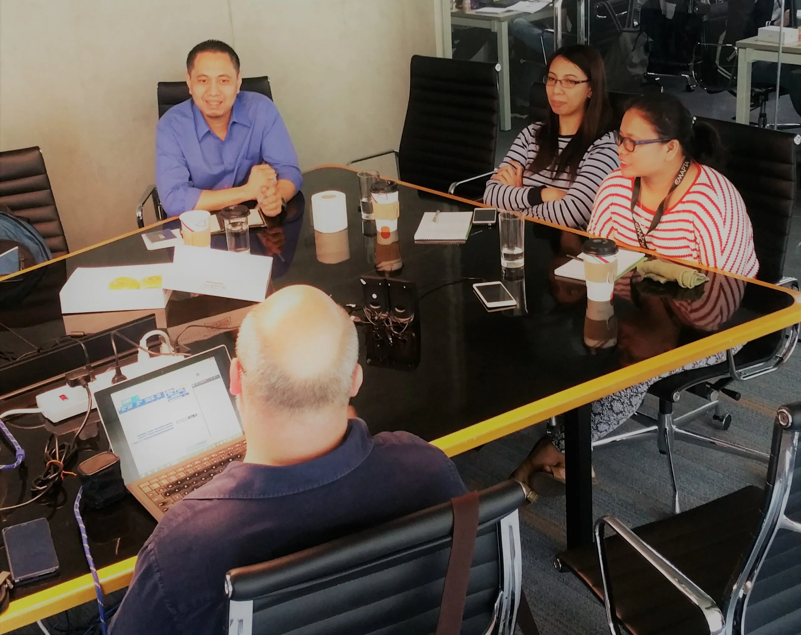 The Acumen Data team in a meeting around a boardroom table