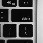 selective focus photo of black and white delete, enter, power button, and F12 computer keys